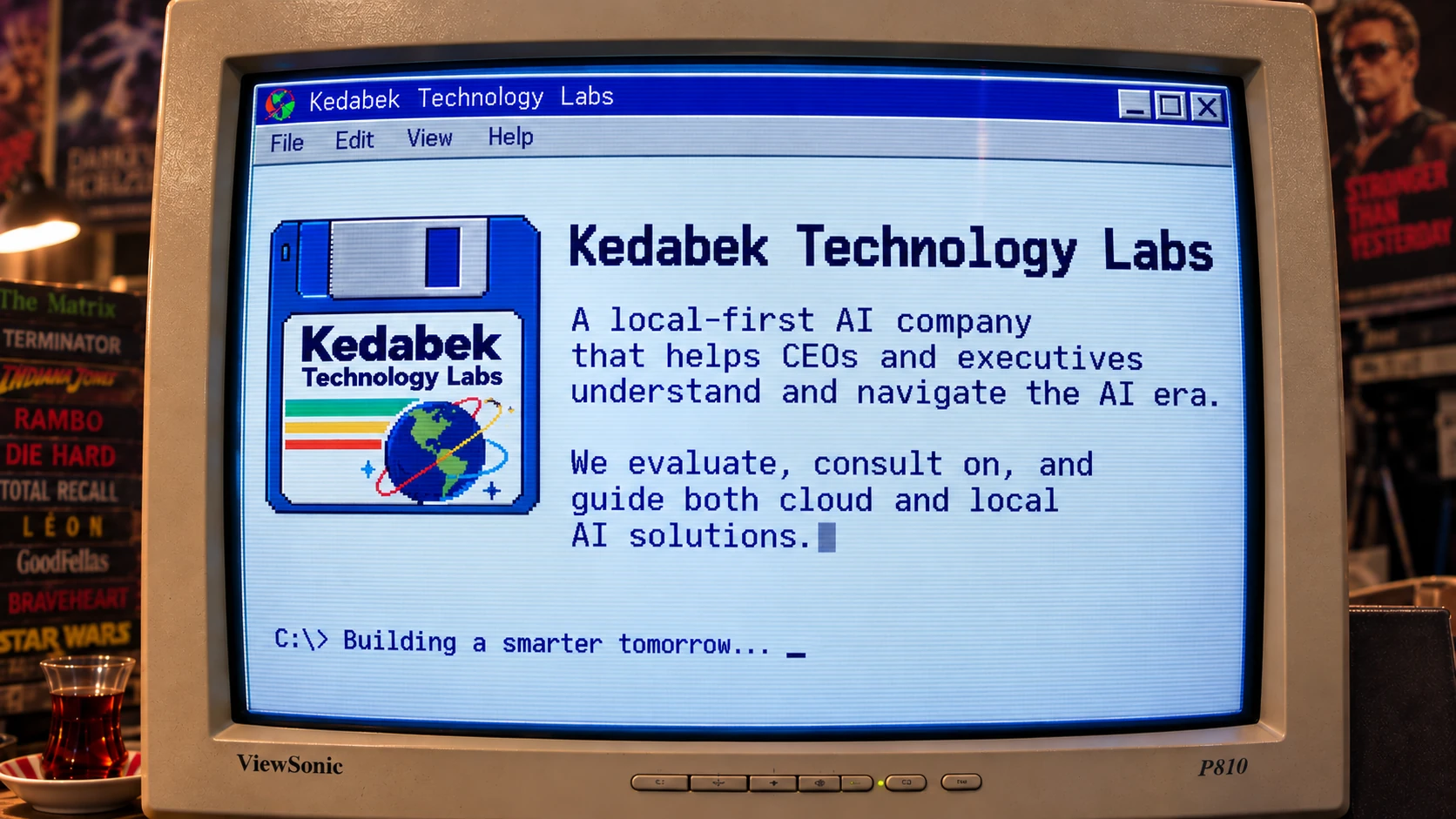 Kedabek Technology Labs — splash screen on a CRT monitor. A local-first AI company that helps CEOs and executives understand and navigate the AI era. We evaluate, consult on, and guide both cloud and local AI solutions. Building a smarter tomorrow.
